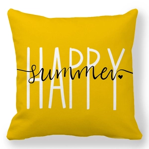 Detail of yellow linen pillowcase featuring artistic Happy Summer print and texture