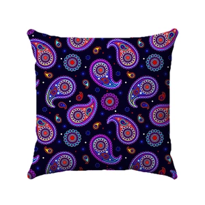 Close-up of vibrant paisley pattern with colorful floral details on a dark linen pillow cover