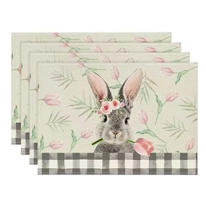 Close-up of four Easter linen placemats with floral rabbit motif and gingham border