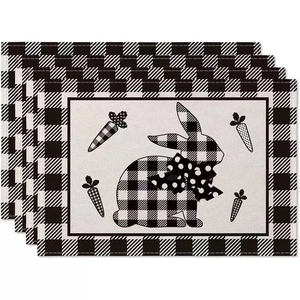 Detail of Easter buffalo plaid rabbit place mats with farmhouse carrot decorations
