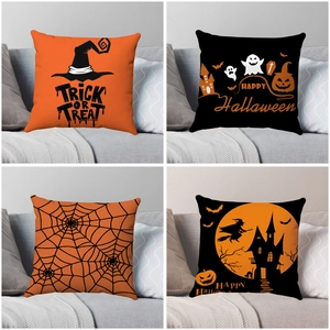 Set of four Halloween pillow covers with witch, ghost, and bat patterns on a sofa