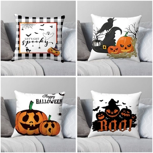 Detailed four-pack of Halloween pillow covers with pumpkin, bat and ghost prints on a sofa