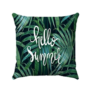 Detail of tropical plant leaf print pillowcase with Hello Summer text on soft fabric