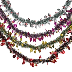 Five styles of Christmas tinsel garland with holly leaves and red berries on white background