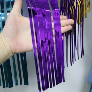 Metallic tinsel fringe curtain backdrop in purple, cyan, and gold for party decoration