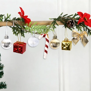 Close-up of Christmas ornaments including baubles, candy canes, and bows on pine branches