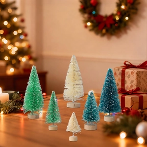 Detailed view of mini sisal Christmas trees with wood bases and snow frosting decor