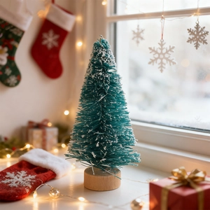 Close-up of mini teal sisal Christmas tree with artificial snow and natural wood base