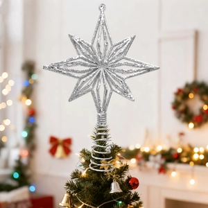 Close-up of sparkling silver star tree topper with glitter finish on a Christmas tree