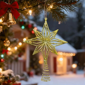 Close-up of a golden glittery eight-point star ornament hanging on a Christmas tree branch