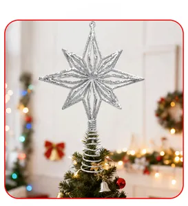 Detailed view of silver glittery star tree topper on a decorated Christmas tree branch