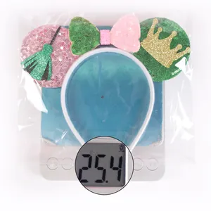 Weight measurement of 25.4g for pink and green sequin mouse ear headband with bow