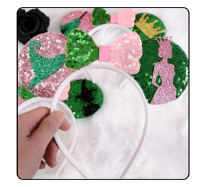 Detail of glitter witch hat and pink bow on sequined mouse ear headband decoration