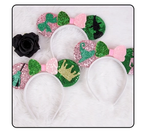 Detail of sequined ears headband with pink and green bows for children party cosplay