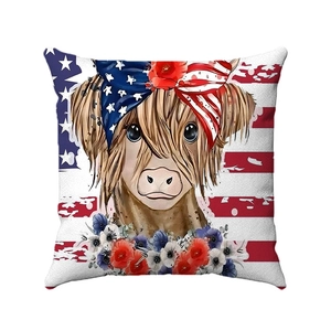 Detail of linen pillow cover with Highland cow wearing US flag bandana and red floral wreath