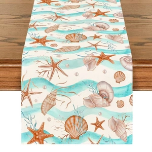 Close-up of linen table runner with ocean starfish and seashell patterns on wood