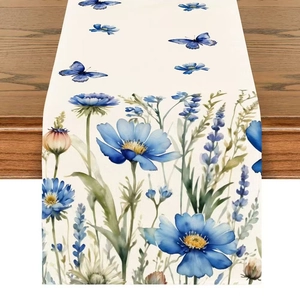 Linen table runner with blue watercolor flowers and butterfly print on wood table