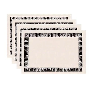 Close-up of four rectangular cream placemats with black Greek key pattern and stitched edges
