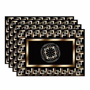 Detailed view of four black and gold geometric placemats with classic Greek key borders
