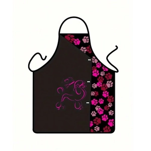 Close-up of black apron with poodle outline and pink paw prints for grooming