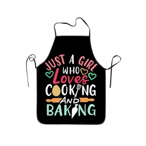 Detail of waterproof black apron with colorful cooking text and baking patterns