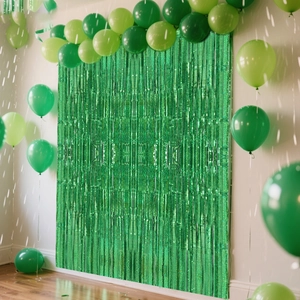 Green laser foil fringe curtain backdrop with matching party balloons decoration
