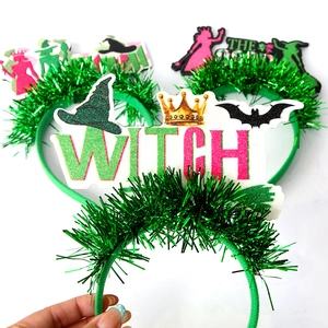 Detailed view of Wicked theme party headbands with green tinsel and glittery Witch letters
