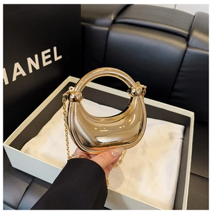 Detailed close-up of a crescent mirror metallic mini handbag with double knot design