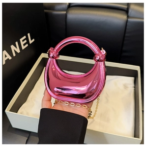 Detailed close-up of a metallic pink mini half-moon bag with a gold chain strap