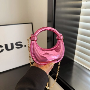 Mini metallic pink crescent handbag with round handle and gold chain strap