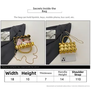 Detail view of gold glossy polka dot mini evening bag with size chart and chain strap