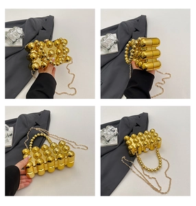 Macro view of gold spherical textured evening clutch with metal chain and top handle