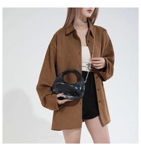 Detail view of smooth caramel brown suede shirt showing collar and front buttons