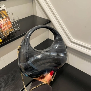 Elegant marble acrylic evening clutch with gold chain strap and circular cutout handle