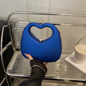 Blue heart-shaped acrylic dinner bag with hollow handle and gold chain shoulder strap
