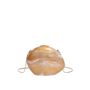 Irregular marble-patterned shell evening clutch with gold chain strap in yellow