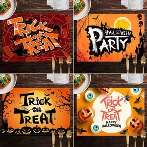 Set of four Halloween table mats featuring spider webs, pumpkins, and bats on linen texture