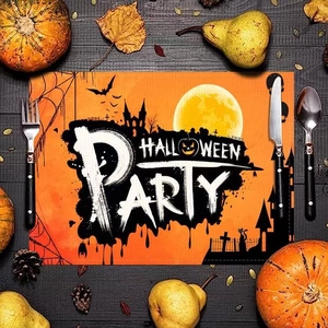Detail of Halloween Party placemat with pumpkin, black cat and bat theme on table