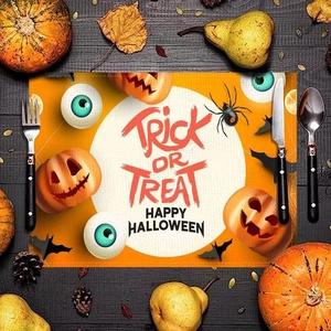 Halloween placemat featuring pumpkins and bats on dark wood background with cutlery