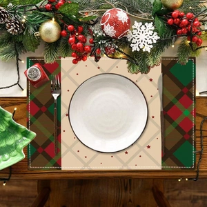 Christmas reindeer placemat with red plaid and star pattern on dark wooden table
