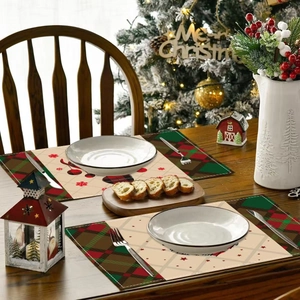 Christmas reindeer placemats with red and green plaid borders on a wooden dining table