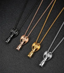 Detailed view of four angel wing perfume bottle pendants in black, gold, rose gold and silver