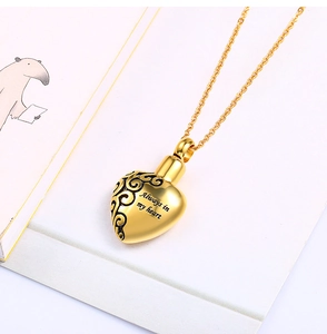 Detailed view of golden heart urn necklace engraved with Always in my heart quote