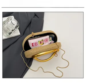Internal storage view of beige woven chain bag showing phone and pouch capacity