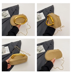 Detail view of woven clutch featuring a modern twisted gold metal handle and chain