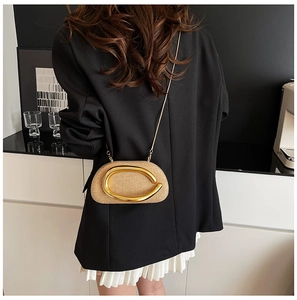 Straw half-moon crossbody bag with polished gold metal hardware and elegant chain strap
