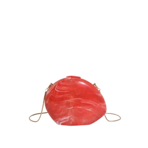 Red marble acrylic shell evening bag with irregular shape and golden metal chain strap