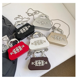 Close-up of evening clutch bags showing rhinestone patterns and metal handles