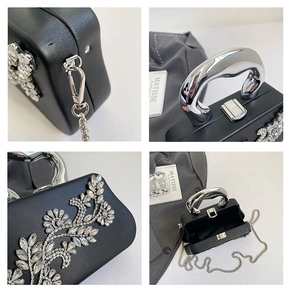 Macro view of crystal flower detail and metallic silver clasp on a black evening bag