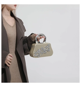 Detail of champagne gold box clutch featuring sparkling crystal floral pattern